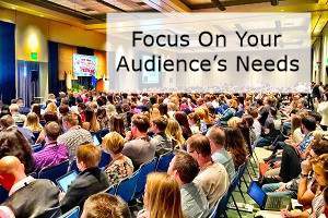 An audience with the words focus on your audience's needs