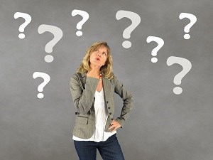 Woman wondering with question marks around her head