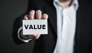 Man holding up a card with the word Value