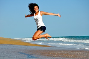 Girl on the beach jumping up