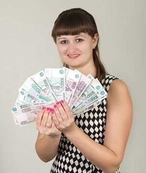 Woman holding fanned banknotes in her hands