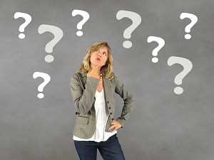 Woman thinking with question marks all around her